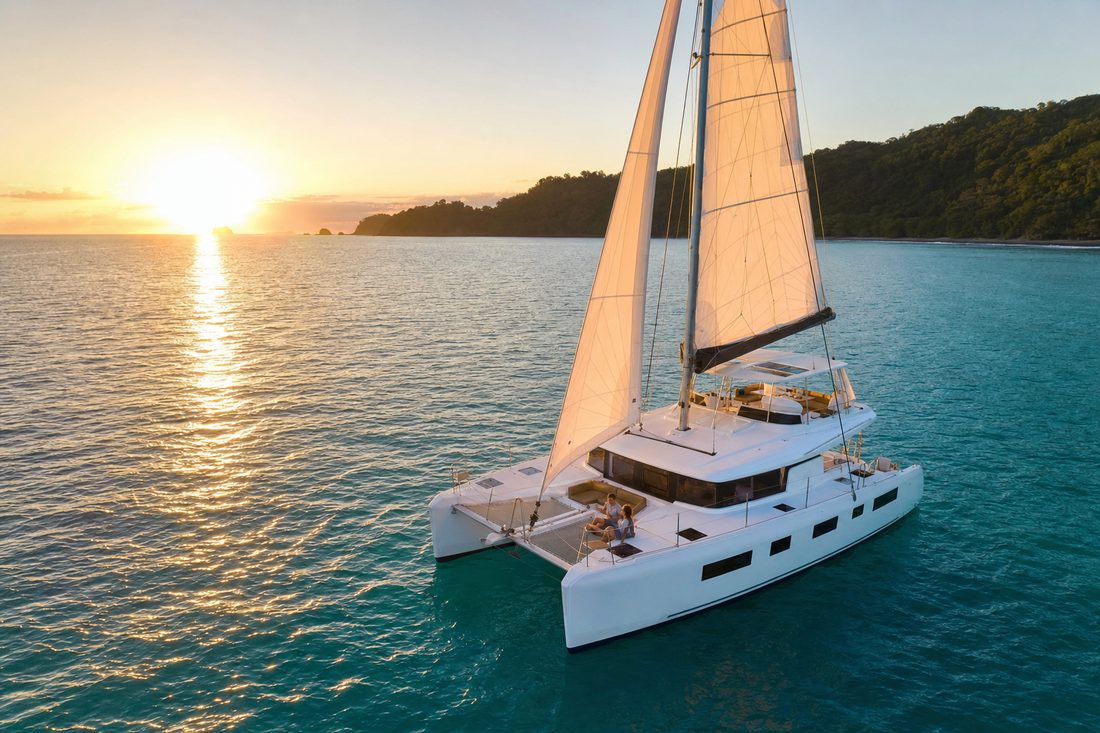 Luxury catamaran sailing on the turquoise Pacific off Costa Rica's Gold Coast at sunset